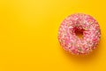 Pink donut on yellow background top view copy space Royalty Free Stock Photo