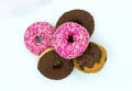 Pink donuts, chocolate donuts and muffin isolated on white.