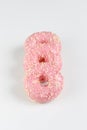 Pink donuts with sprincles on white Royalty Free Stock Photo