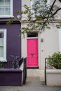 Pink door on a cream color British house Royalty Free Stock Photo