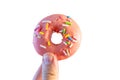 pink doughnut in a woman's hand