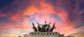 Pink dramatic skies during sunset over the bronze horses at corte di cassazione supreme court in Rome