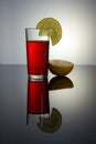 Pink drink in a glass glass Cup with reflection, a slice of lemon and orange Royalty Free Stock Photo