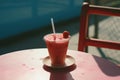 a pink drink sitting on top of a table