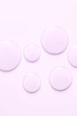 Pink drops of moisturizing gel or serum. Cosmetic product for skin care. Copy space.