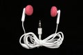 Pink Earbuds black background