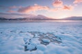 Pink early morning glow light on snow covered mountains in arctic norway, super wide panoramic scene. Scenic winter view