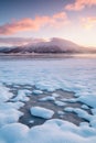 Pink early morning glow light on snow covered mountains in arctic norway, super wide panoramic scene. Scenic winter view Royalty Free Stock Photo