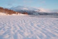 Pink early morning glow light on snow covered mountains in arctic norway, super wide panoramic scene. Scenic winter view