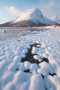 Pink early morning glow light on snow covered mountains in arctic norway, super wide panoramic scene. Scenic winter view