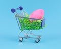 Pink Easter egg in shopping cart for Easter shopping concept Royalty Free Stock Photo