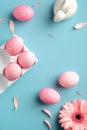 Pink Easter eggs, bunny rabbit, spring flowers on turquoise background. View from above, flat lay. Vertical banner for social Royalty Free Stock Photo