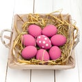 Pink Easter eggs on wodden background. Still life photo of lots of pink easter eggs. Copyspace.