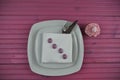 Pink Easter time table place setting in white and decorated with pretty egg shapes and a strawberry flavor cupcake