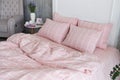 Pink ecologycal linen on bed in modern home interior. Daylight Royalty Free Stock Photo