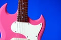 Pink Electric Guitar Isolated On Blue Royalty Free Stock Photo
