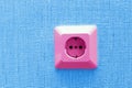 Pink electric socket on blue wall Royalty Free Stock Photo