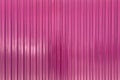 Pink embossed metal surface close up background