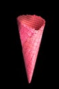 Pink empty wafer cone on dark background