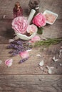 Pink English rose, lavender, organic salt and oil, spa wooden background. Rustic style.