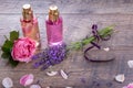 Pink English rose, lavender, organic salt and oil, spa wooden background. Rustic style