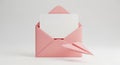 Pink Envelope with a Blank White Card and a Paper Airplane on White Background image Royalty Free Stock Photo