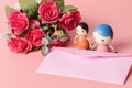 Pink envelope with couple doll Royalty Free Stock Photo