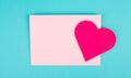 Pink envelope with a heart, empty copy space, blue background, valintines day greeting card, romantic mail, love letter