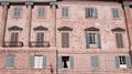 The pink facade of an old medieval building decorated with columns and capitals Italy, Europe Royalty Free Stock Photo