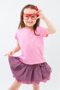 Pink fashionista hand holding red glasses. Royalty Free Stock Photo