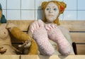 Pink feet of giant life-sized stuffed doll depicting female relaxing in Finnish sauna