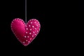 Pink felt heart on the rope. Handmade isolate on black background