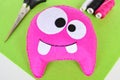 Pink felt monster - handmade toy. Step by step. Halloween diy crafts decoration tutorials. DIY monster doll sewing for kids photo Royalty Free Stock Photo
