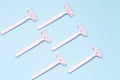 Pink female razors isolated on the blue background. Set of razors on blue background. Pink women`s disposable razors . Royalty Free Stock Photo