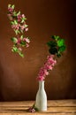 Pink fieldflowers branch inside glass vase