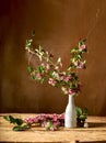 Pink fieldflowers branch inside glass vase