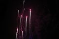 Pink fireworks flying at night sky, black sky