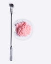 Pink flake chemicals in chemical watch glass placed next to the stirring rod on laboratory table Royalty Free Stock Photo