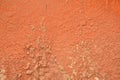 Pink flaky paint on the outer wall of building. Background of old pink plaster on a cement wall Royalty Free Stock Photo