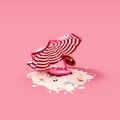 Pink flamingo inflatable with beach parasol on pink background. Summer travel concept background.