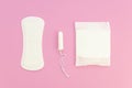 Pink flat lay compostion feminine pads and tampons on a pastel pink background. Menstrual cycle idea