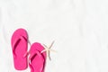 Pink flip flop put or step on on White sandy beach background Royalty Free Stock Photo