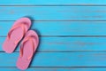 Pink flip flop sandals old summer beach wood background painted blue