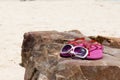 Pink flip flop shoes and Fashion sunglasses on the rock of beach. Summer Concept Royalty Free Stock Photo