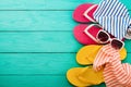 Pink flip flops, towel, sunglasses and copy space on blue wooden background. Top view. Beach summer holiday concept. Royalty Free Stock Photo