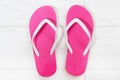 Pink flip-flops on a white wooden background close up Royalty Free Stock Photo