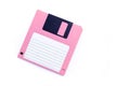 Pink floppy disk on white background