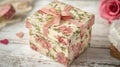A Pink Floral Gift Box with a Bow on a Wooden Surface Royalty Free Stock Photo