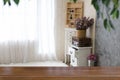 pink flower in basket on vintage white cabinet at corner of living room with wood table for montage or display your product Royalty Free Stock Photo