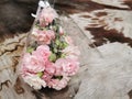 pink flower bouquet on wet wood